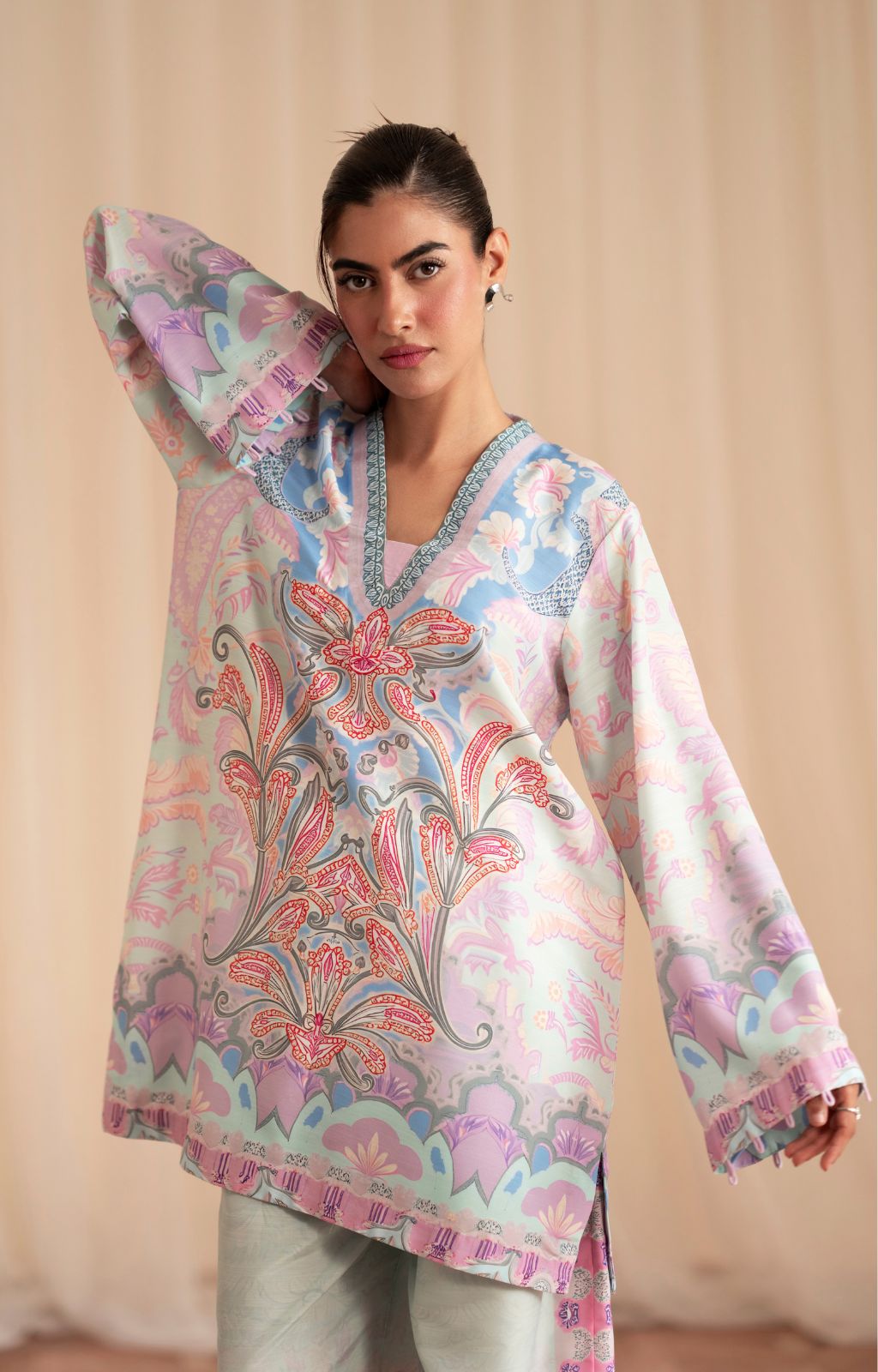Woman wearing a floral patterned top with a plain background