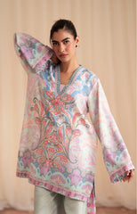 Woman wearing a floral patterned top with a plain background