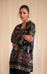 Woman wearing a floral embroidered dress against a beige background